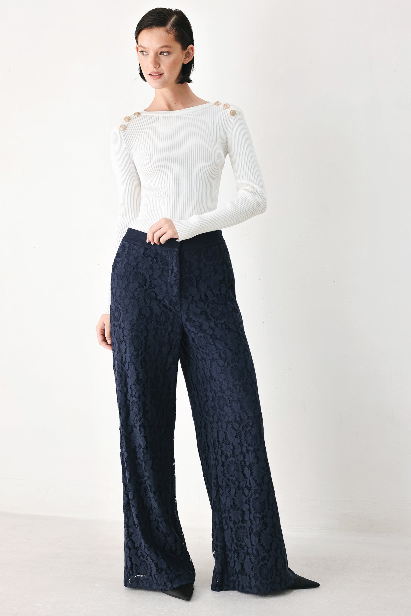 A model wearing dark navy lace wide-leg pants | FREEMARKET