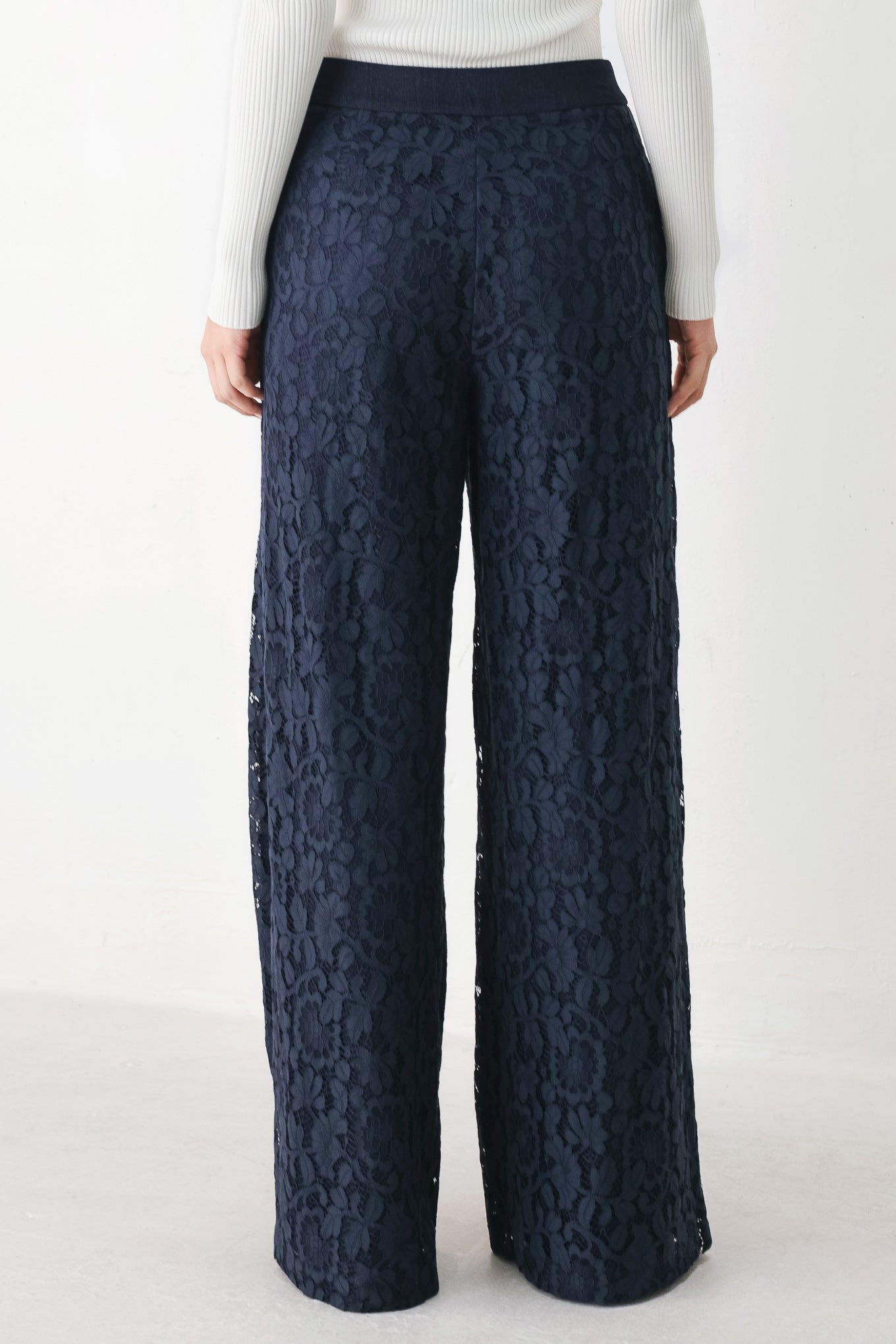 A model wearing dark navy lace wide-leg pants | FREEMARKET