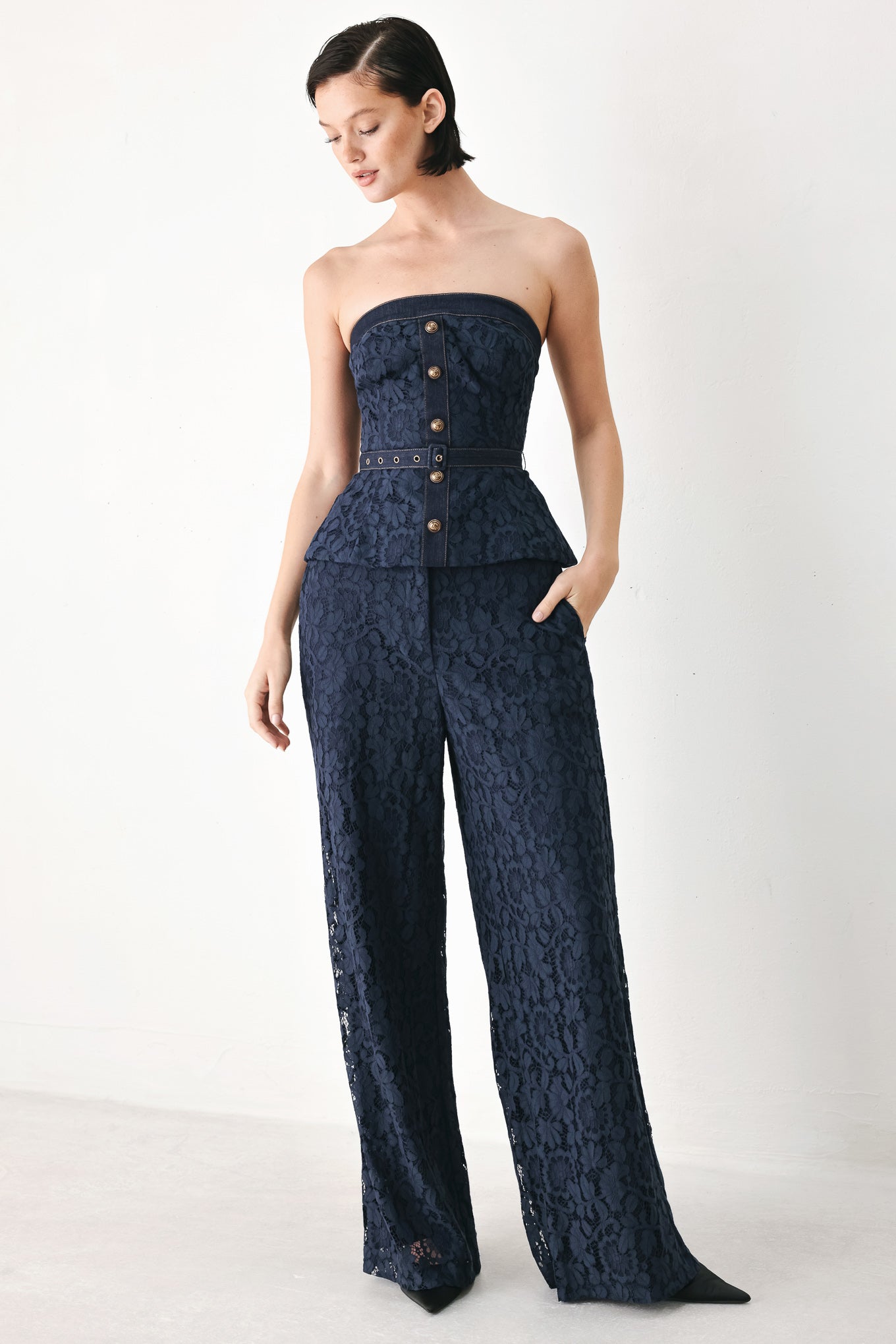 A model wearing dark navy lace wide-leg pants | FREEMARKET