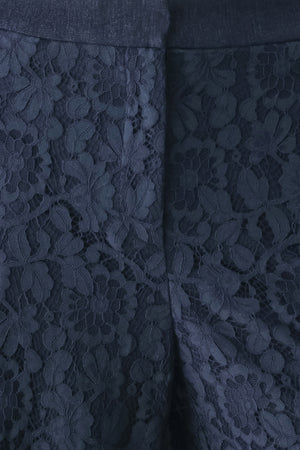A model wearing dark navy lace wide-leg pants | FREEMARKET