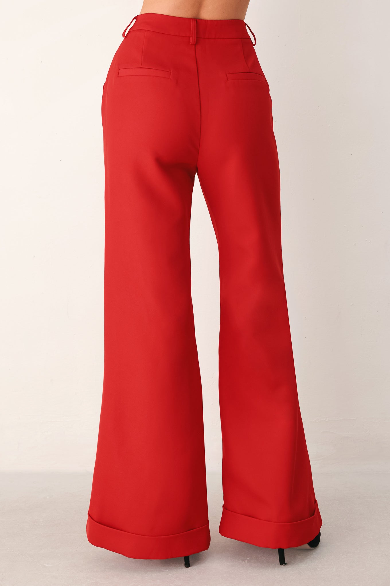 Red wide-leg cropped pants with rolled cuffs, shown on a model | FREEMARKET