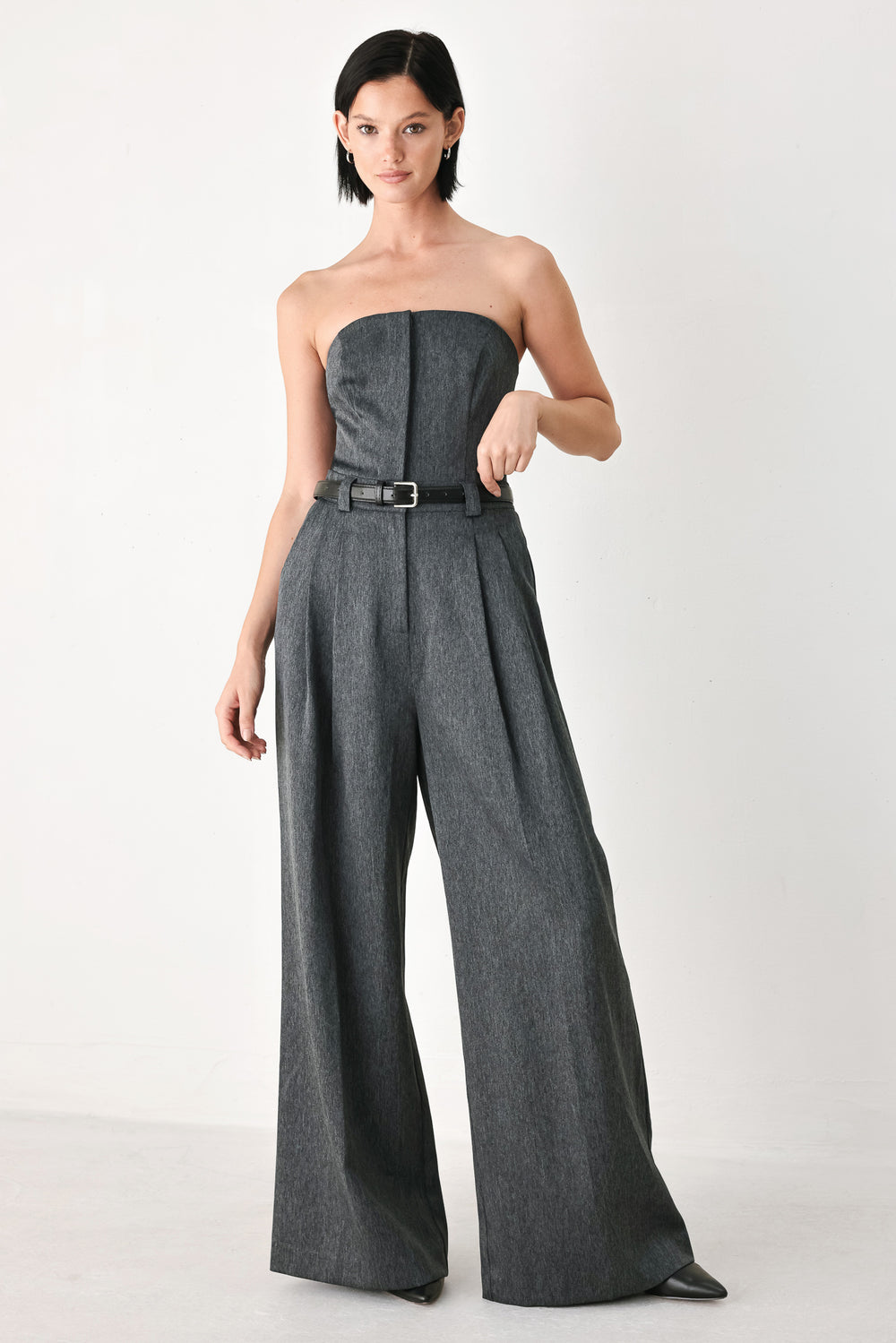 A model wearing a dark gray strapless wide-leg jumpsuit with a matching belt | FREEMARKET