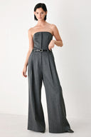 A model wearing a dark gray strapless wide-leg jumpsuit with a matching belt | FREEMARKET
