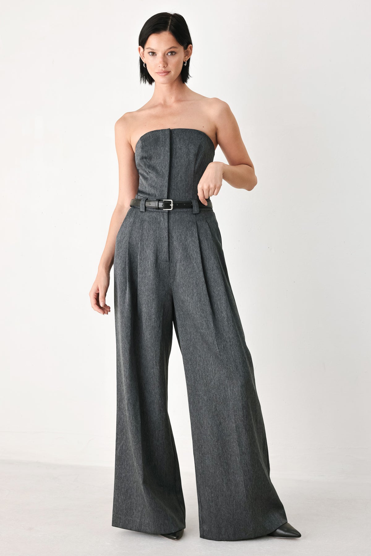 A model wearing a dark gray strapless wide-leg jumpsuit with a matching belt | FREEMARKET