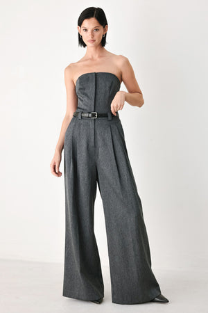 A model wearing a dark gray strapless wide-leg jumpsuit with a matching belt | FREEMARKET
