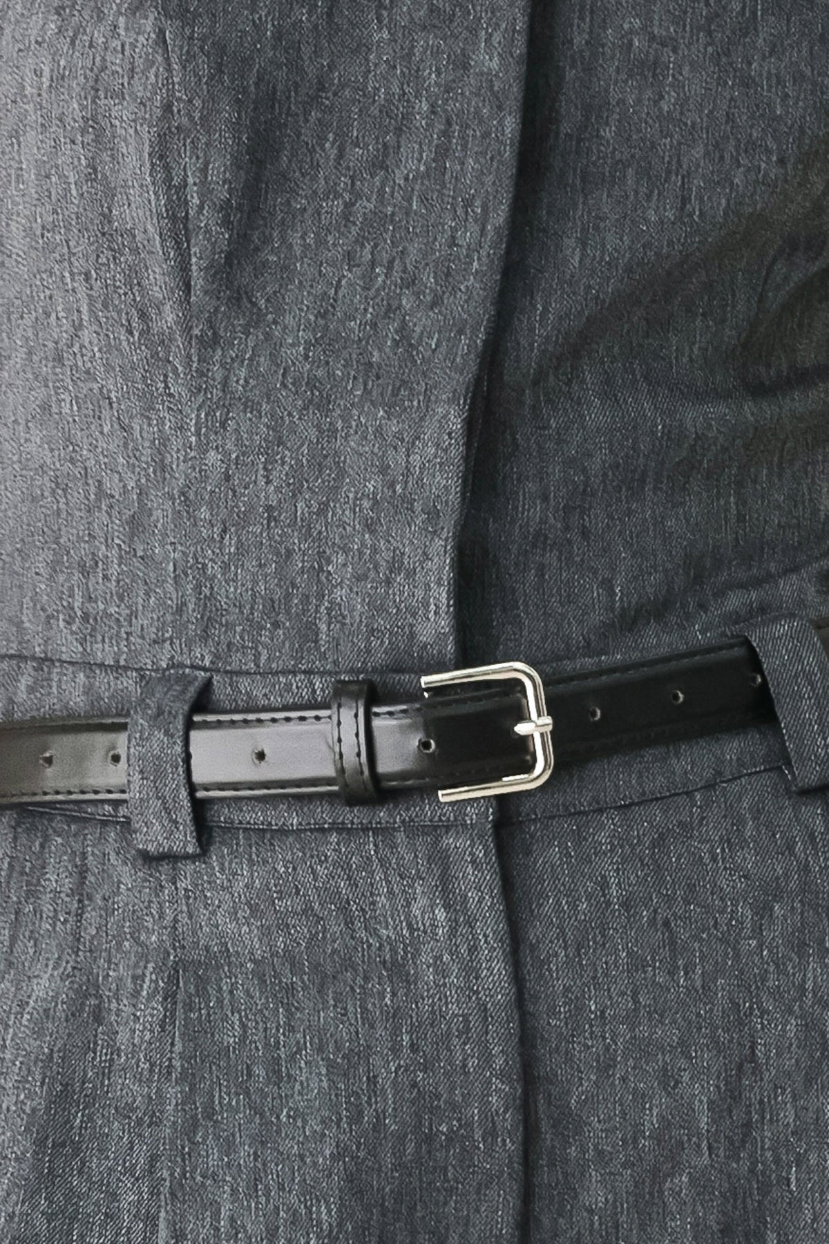 A model wearing a dark gray strapless wide-leg jumpsuit with a matching belt | FREEMARKET