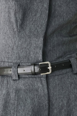 A model wearing a dark gray strapless wide-leg jumpsuit with a matching belt | FREEMARKET