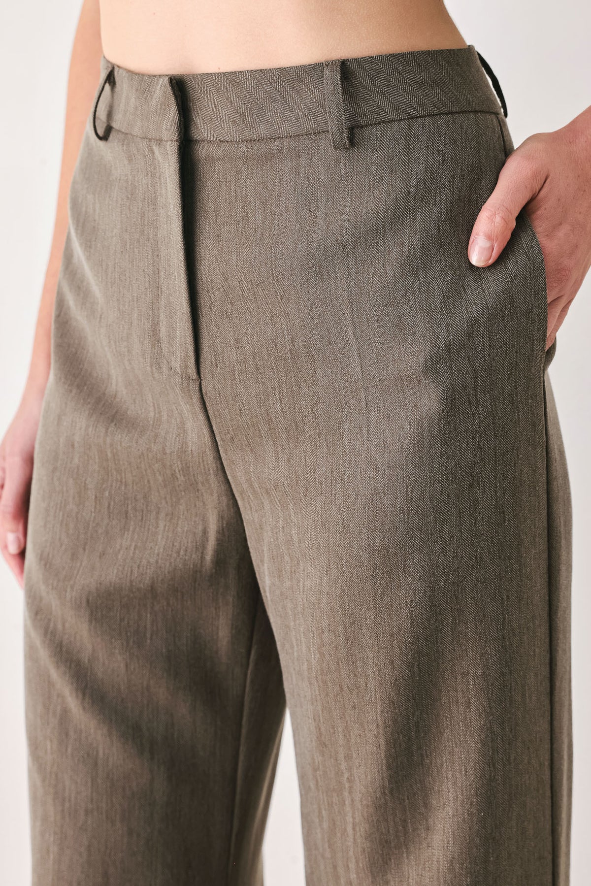 Woman wearing brown tailored flared pants with a big cuff at the bottom | FREEMARKET