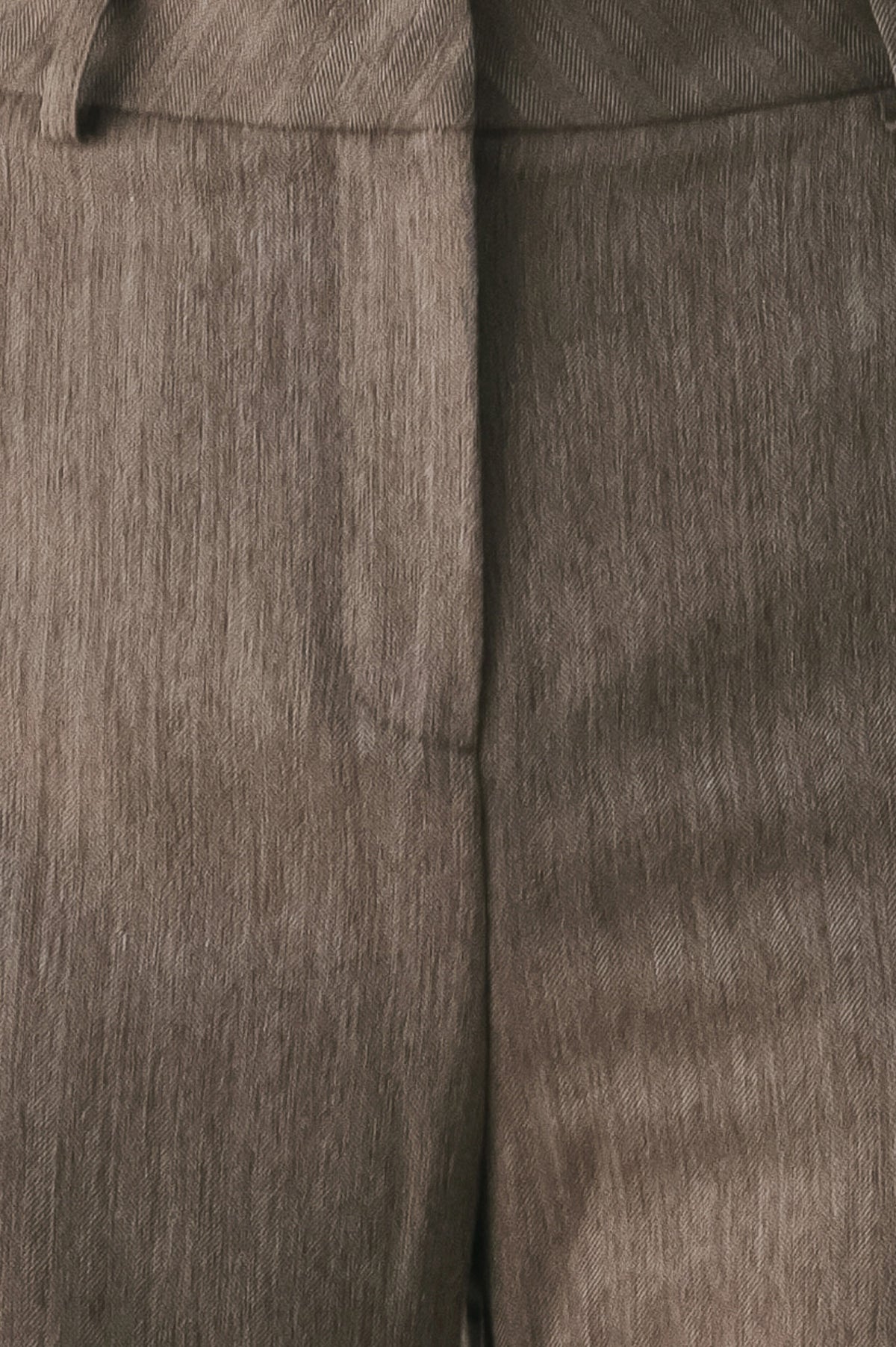 Woman wearing brown tailored flared pants with a big cuff at the bottom | FREEMARKET