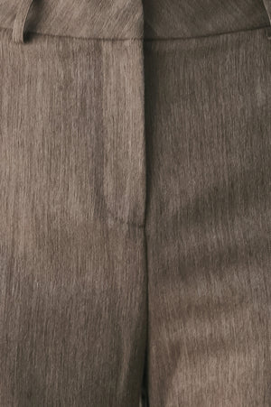 Woman wearing brown tailored flared pants with a big cuff at the bottom | FREEMARKET