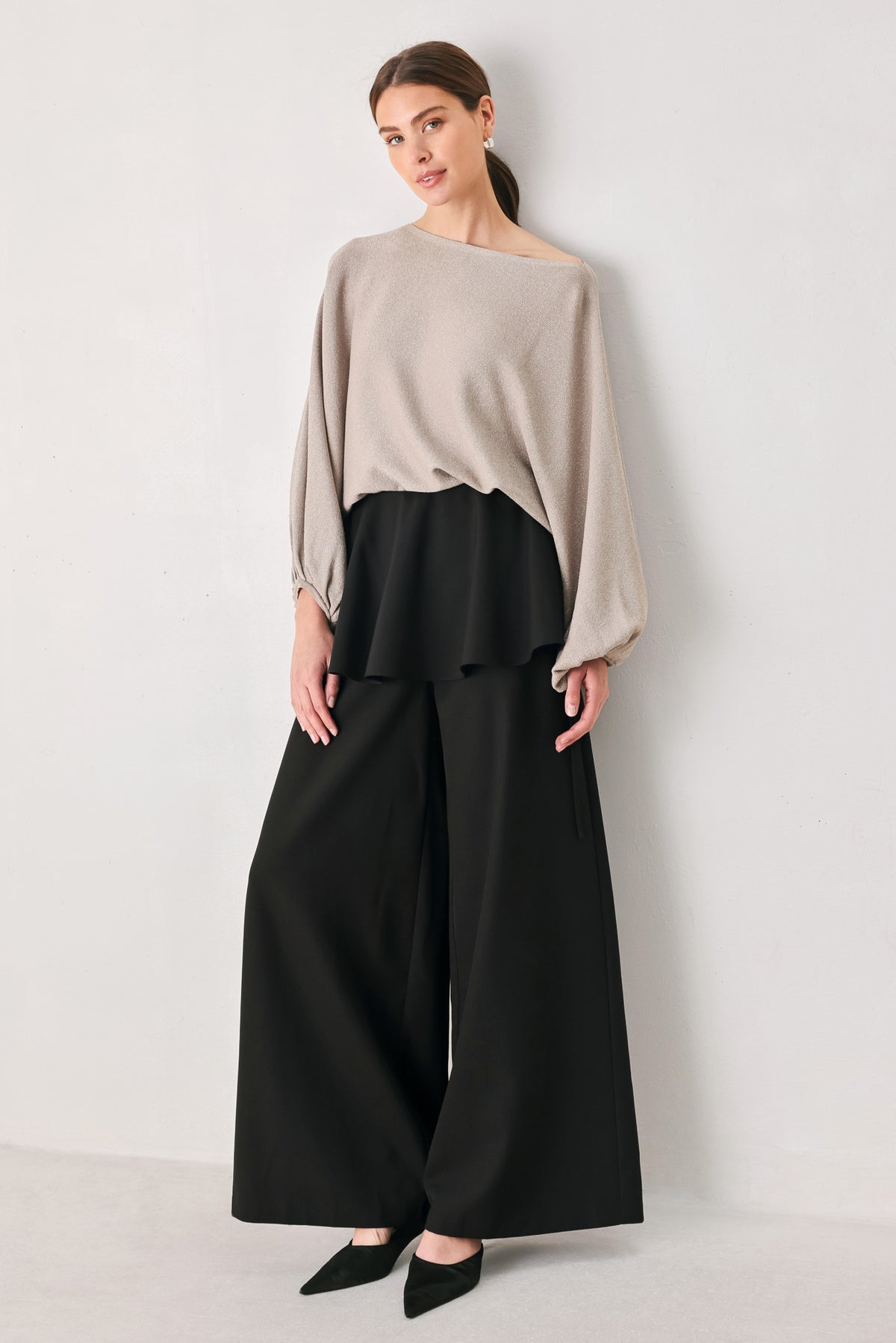 Black wide-leg pants with a dramatic layered ruffle waistband, shown on a model | FREEMARKET