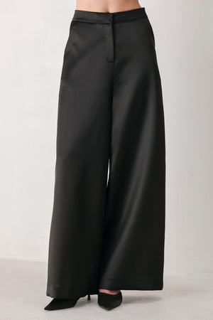 Black wide-leg trousers with a satin-like sheen, shown on a model | FREEMARKET
