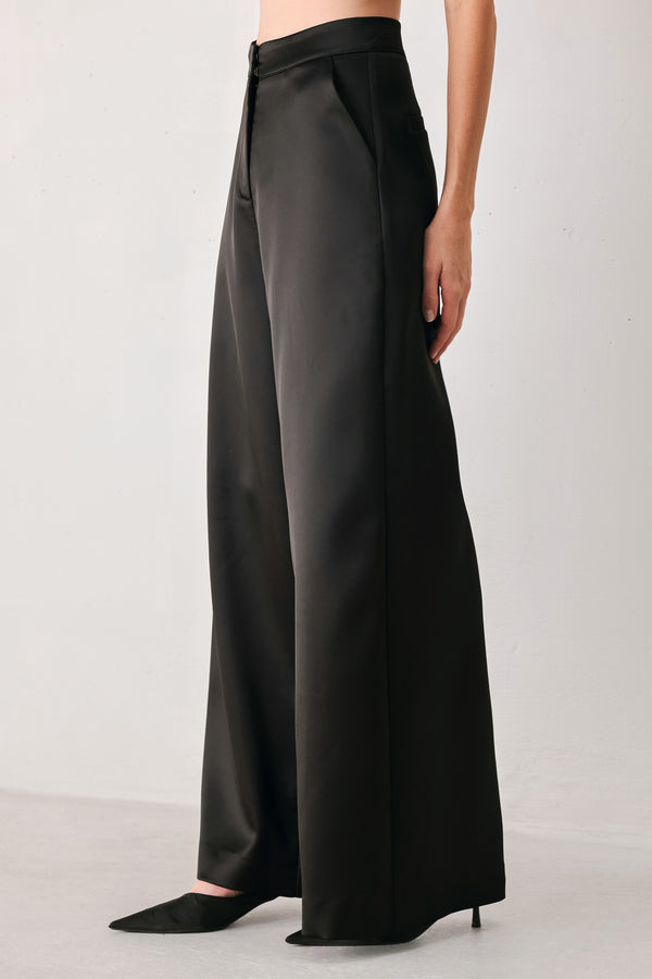 Black wide-leg trousers with a satin-like sheen, shown on a model | FREEMARKET