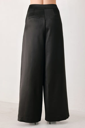 Black wide-leg trousers with a satin-like sheen, shown on a model | FREEMARKET