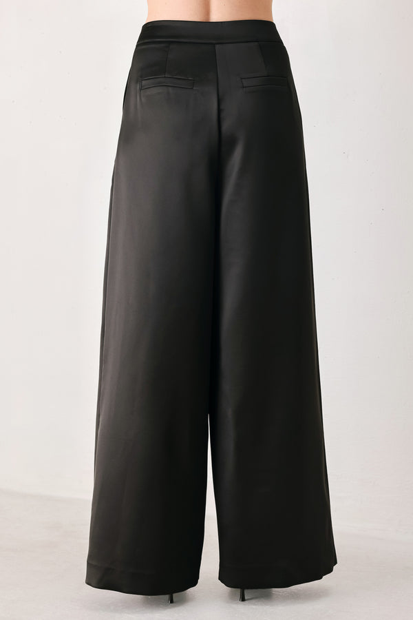 Black wide-leg trousers with a satin-like sheen, shown on a model | FREEMARKET