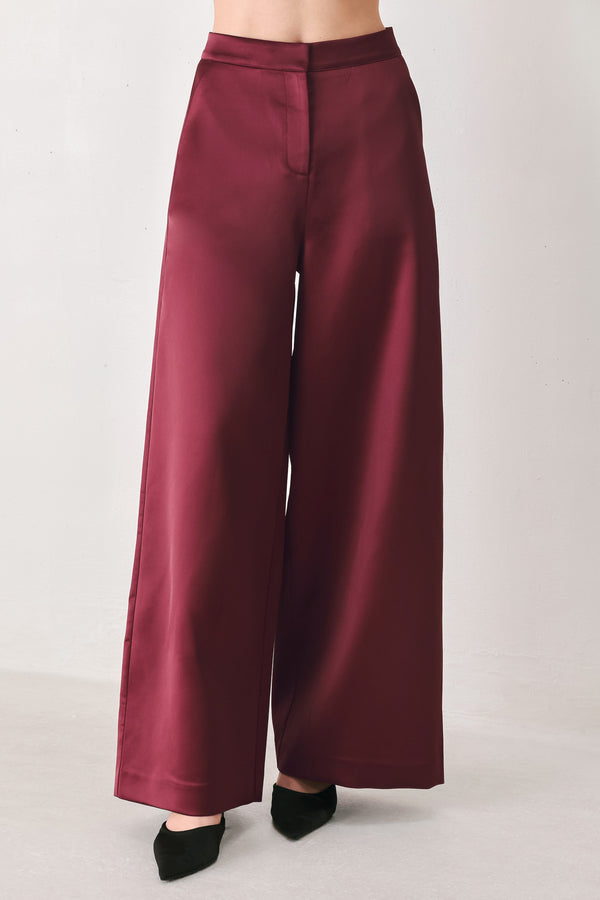 Burgundy wide-leg trousers with a satin-like sheen, shown on a model | FREEMARKET