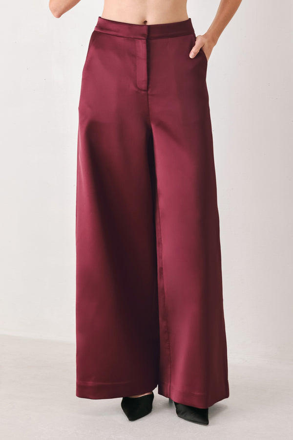 Burgundy wide-leg trousers with a satin-like sheen, shown on a model | FREEMARKET