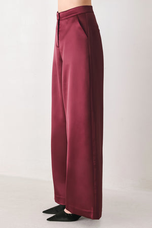 Burgundy wide-leg trousers with a satin-like sheen, shown on a model | FREEMARKET