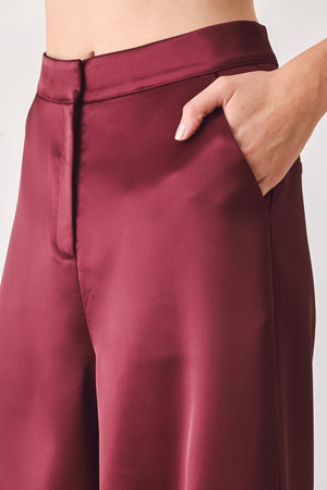 Burgundy wide-leg trousers with a satin-like sheen, shown on a model | FREEMARKET