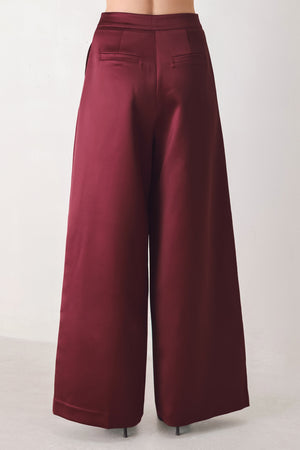 Burgundy wide-leg trousers with a satin-like sheen, shown on a model | FREEMARKET