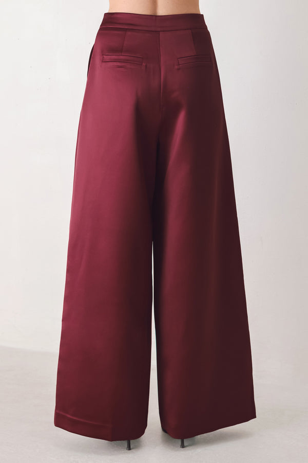 Burgundy wide-leg trousers with a satin-like sheen, shown on a model | FREEMARKET