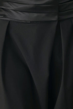A model wearing high-waisted, wide-leg black trousers with a satin-like waistband | FREEMARKET