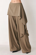 Woman wearing wide leg high waisted pants with a skirt draping over | FREEMARKET