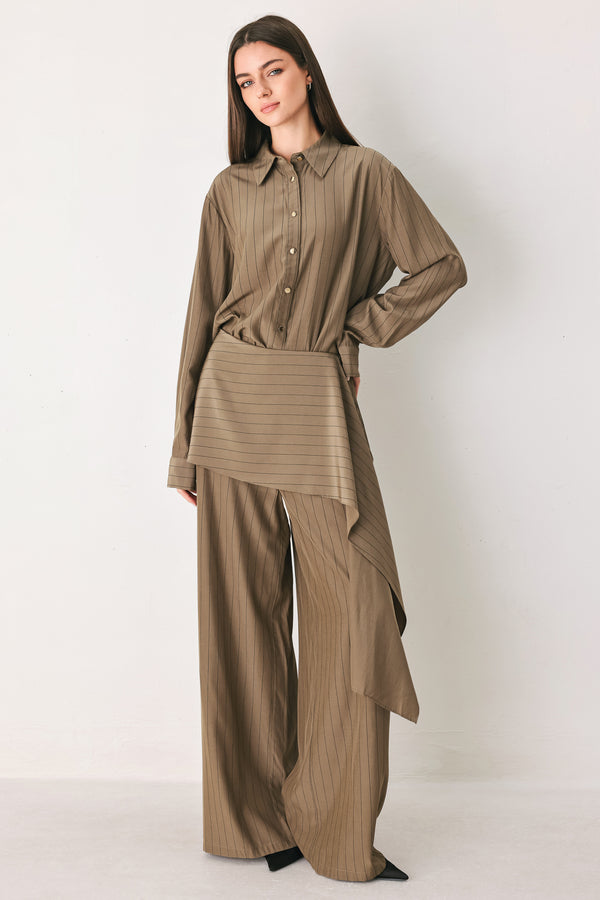 Woman wearing wide leg high waisted pants with a skirt draping over | FREEMARKET