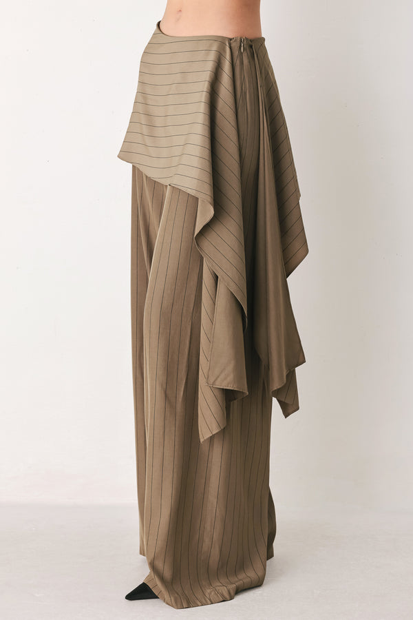 Woman wearing wide leg high waisted pants with a skirt draping over | FREEMARKET