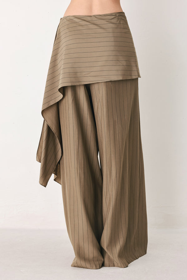 Woman wearing wide leg high waisted pants with a skirt draping over | FREEMARKET