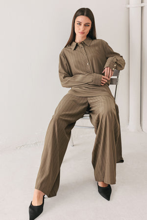 Woman wearing wide leg high waisted pants with a skirt draping over | FREEMARKET