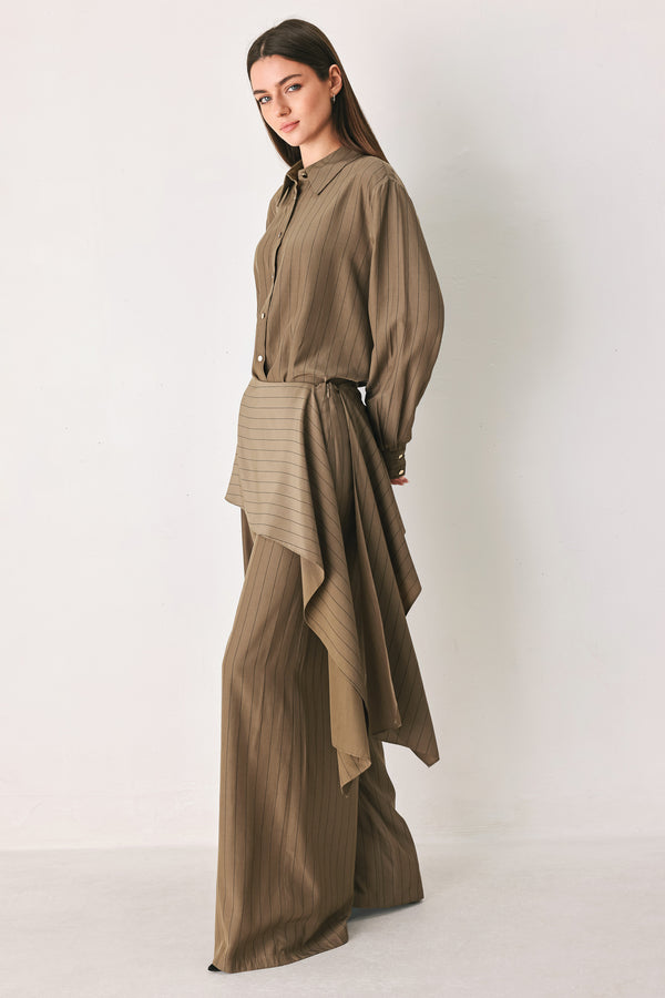 Woman wearing wide leg high waisted pants with a skirt draping over | FREEMARKET