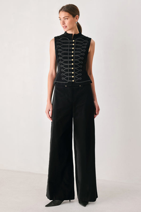 Woman wearing a pair of high waisted velvet pants and with double breasted buttons on the waistband | FREEMARKET