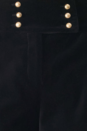 Woman wearing a pair of high waisted velvet pants and with double breasted buttons on the waistband | FREEMARKET