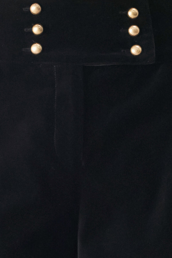 Woman wearing a pair of high waisted velvet pants and with double breasted buttons on the waistband | FREEMARKET