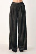 Black wide-leg trousers with thin white vertical pinstripes, shown on a model | FREEMARKET