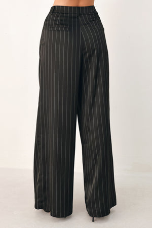 Black wide-leg trousers with thin white vertical pinstripes, shown on a model | FREEMARKET