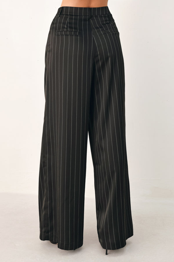 Black wide-leg trousers with thin white vertical pinstripes, shown on a model | FREEMARKET