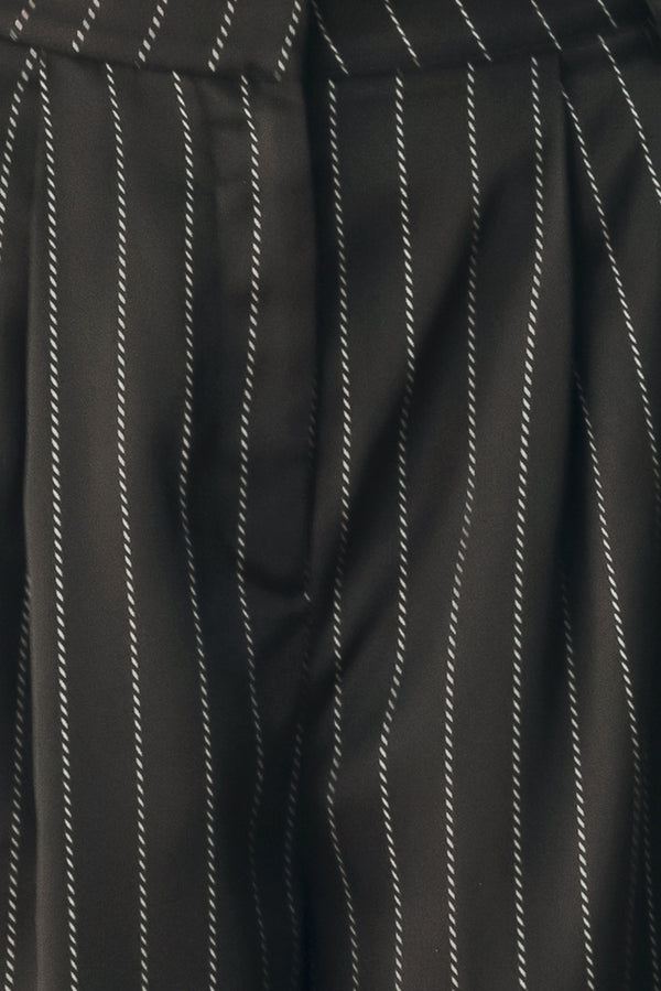 Black wide-leg trousers with thin white vertical pinstripes, shown on a model | FREEMARKET