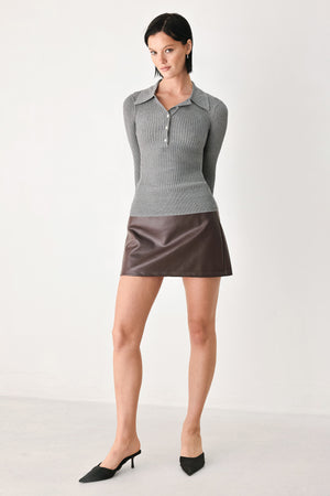 A woman wearing a gray ribbed long-sleeve polo-neck knit top | FREEMARKET