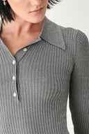 A woman wearing a gray ribbed long-sleeve polo-neck knit top | FREEMARKET