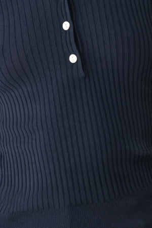 A woman wearing a navy blue ribbed long-sleeve polo-neck knit top | FREEMARKET