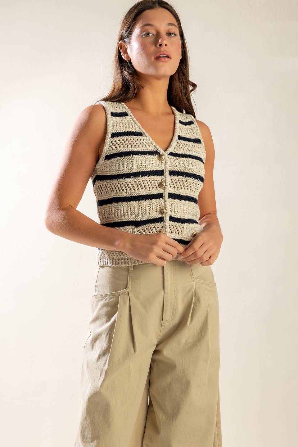 A sleeveless striped sweater knit vest with button down.