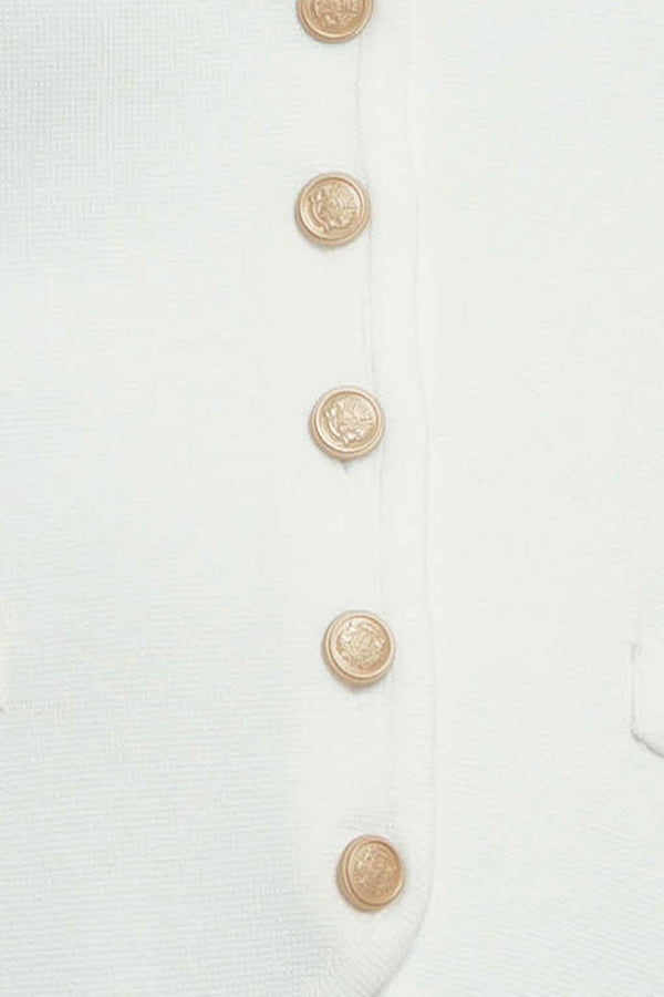 A solid white sweater vest with front button closure
