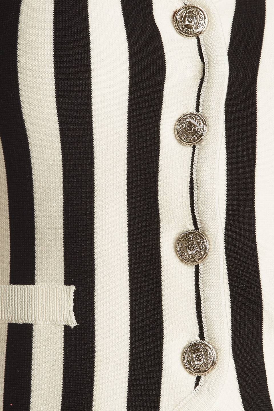 A striped white and black sweater knit vest with front button closure.