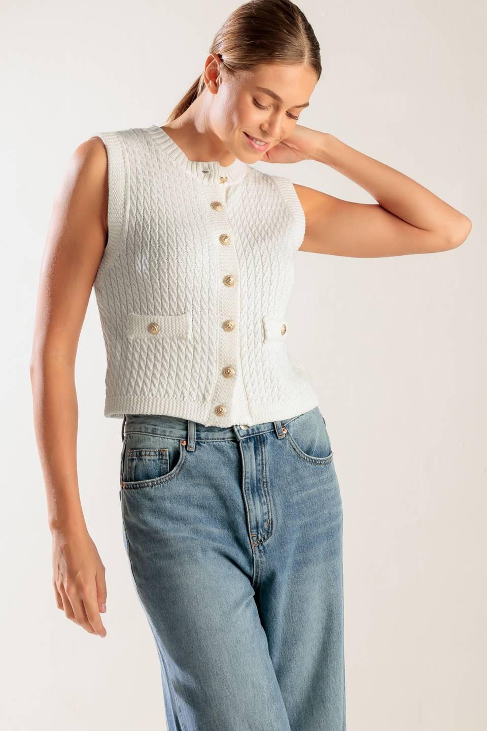 A white, sleeveless, sweater knit vest featuring round neckline and button down closure.