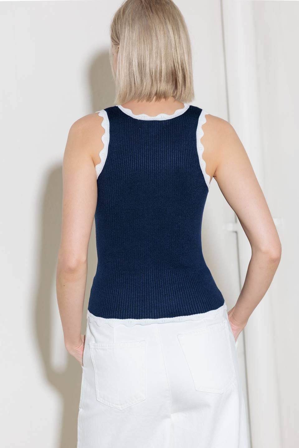 A sweater knit tank top with contrasting trimmed edge.