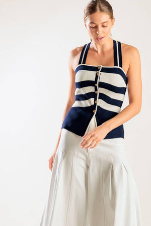 A navy and white striped sweater knit top featuring a halter neckline button down closure and cross back strap.
