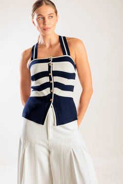A navy and white striped sweater knit top featuring a halter neckline button down closure and cross back strap.