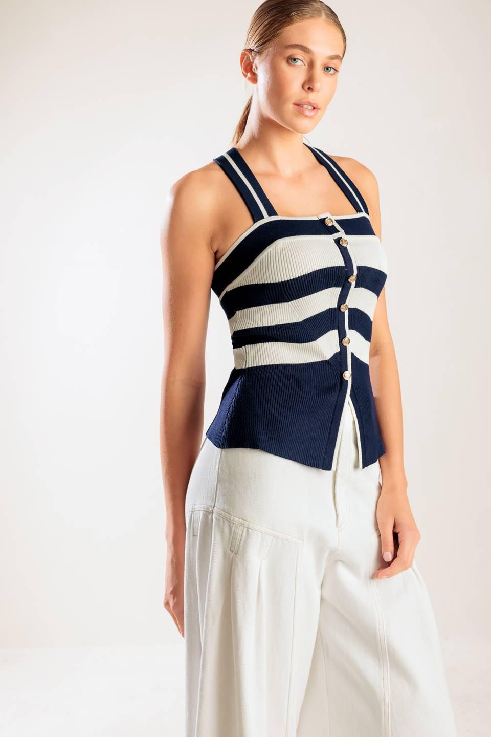 A navy and white striped sweater knit top featuring a halter neckline button down closure and cross back strap.